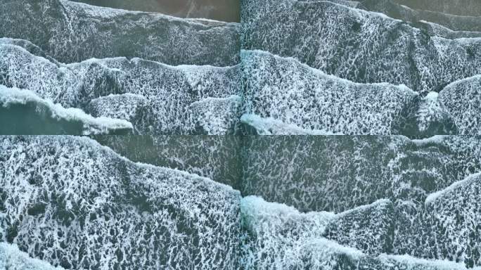 蓝绿色波浪冲击礁石