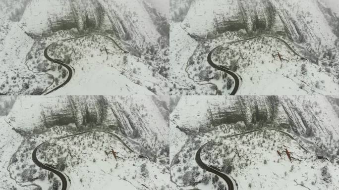 加州山区新雪覆盖的乡村道路航拍推进镜头。