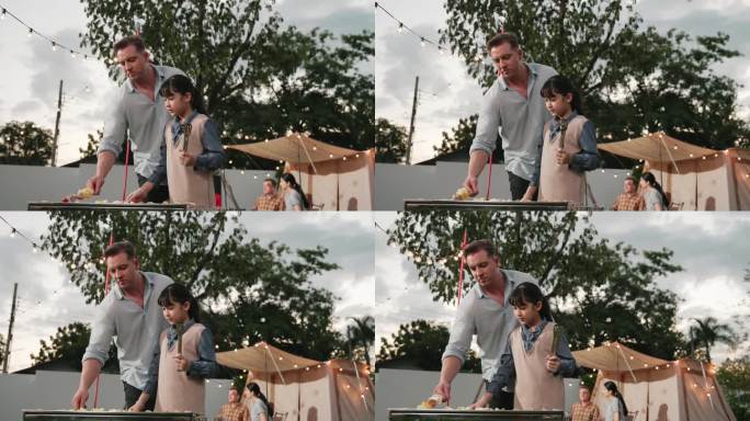 全家一起在花园露营，父亲和女儿在烤食物。分歧。