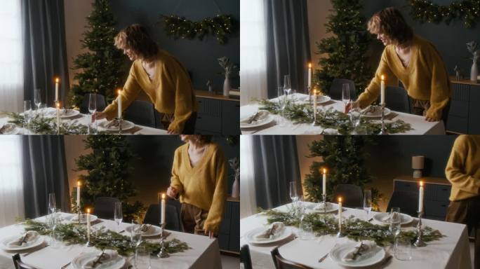 女人在节日餐桌上放置香槟杯以庆祝圣诞节。