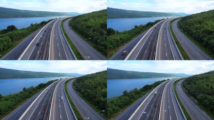 沿着河流的高架道路和高速公路在雨季蜿蜒于山脉的美丽曲线，泰国那空叻差斯马府的兰塔孔水坝两侧绿树成荫。