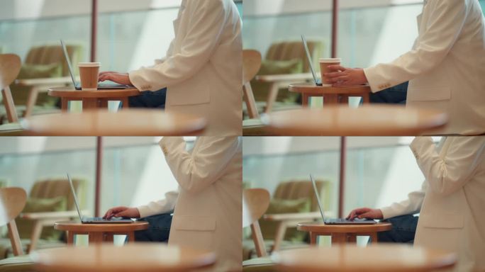 穿着得体的女性坐在咖啡馆里工作。