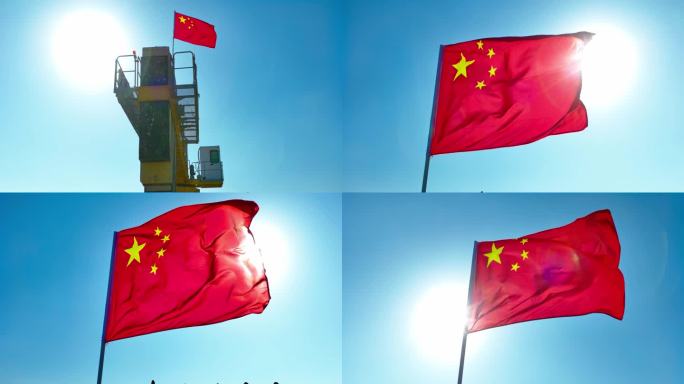 航拍工地高塔上红旗飘扬