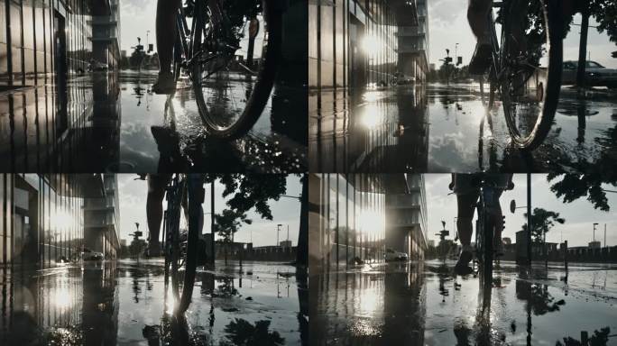 在日落时分，轻微降雨中，女人骑自行车在湿滑的城市人行道上的表面镜头。