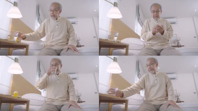亚洲老人坐在床上看书，然后在适当的时间吃药，然后继续在家看书
