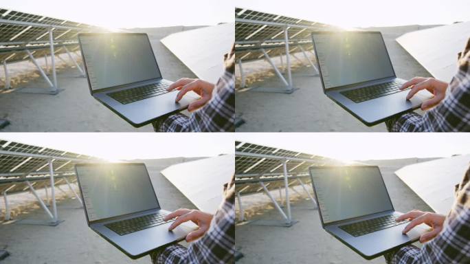 男工程师在太阳能发电站使用笔记本电脑。