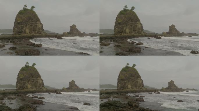 在多云的天空的海上岩石形成的空中向后风景视图-爪哇，印度尼西亚