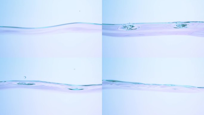 从较低的角度近距离观察慢动作水面，同时有几滴水落入水中，产生涟漪