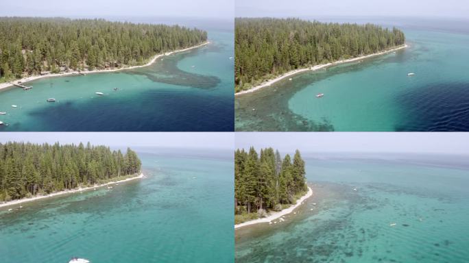 空中淘太浩湖的岩石海岸线，轻轻地荡漾的波浪，度假屋，船，码头，深蓝色的水，和高大的绿色松树-米克斯湾