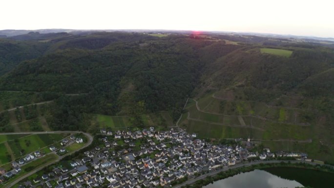 空中拍摄的住宅在城镇的小山，无人机飞行向前越过摩泽勒河-布雷姆，德国