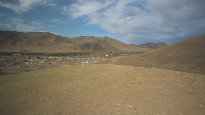 潘:蒙古乌兰巴托，岩石山旁边的村庄，上面有天空映衬的风景的欢迎文字