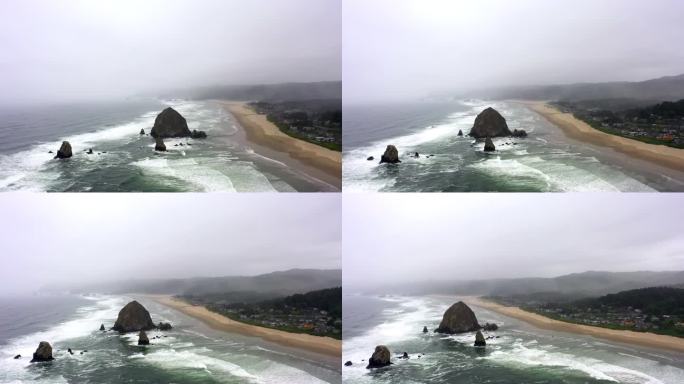 空中平移拍摄的海浪溅在海滩上对多云的天空，无人机飞过海岸附近的城市-坎农海滩，俄勒冈州