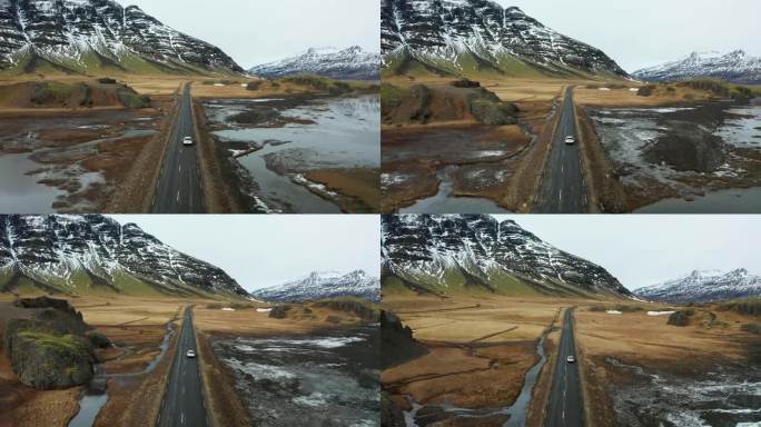 冰岛火山景观上的美丽道路。无人机在汽车后面飞行。