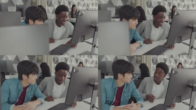 在课堂上学习计算机技术的学生