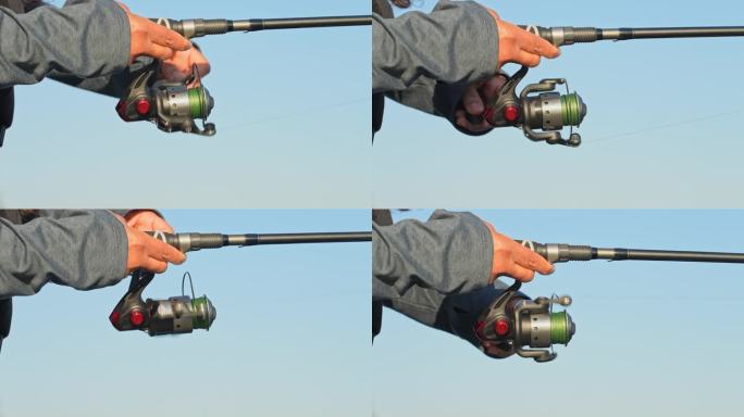 钓鱼竿投向湖中钓鱼。夏季傍晚，一位女性钓鱼者在湖边抛竿，使用编织轮的钓鱼线。特写慢动作。渔女的手。