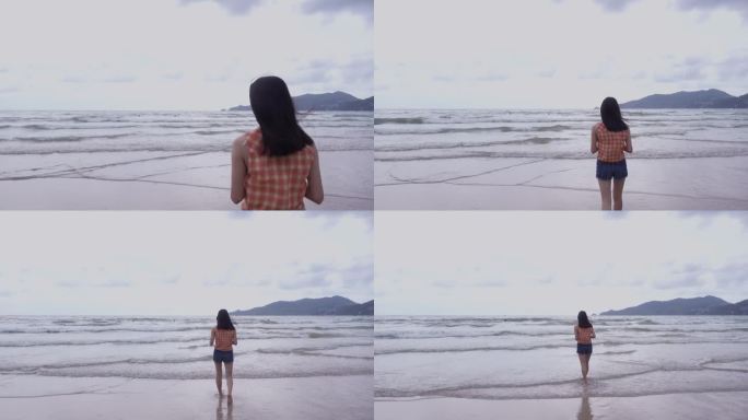 女孩在海边的沙滩上玩耍