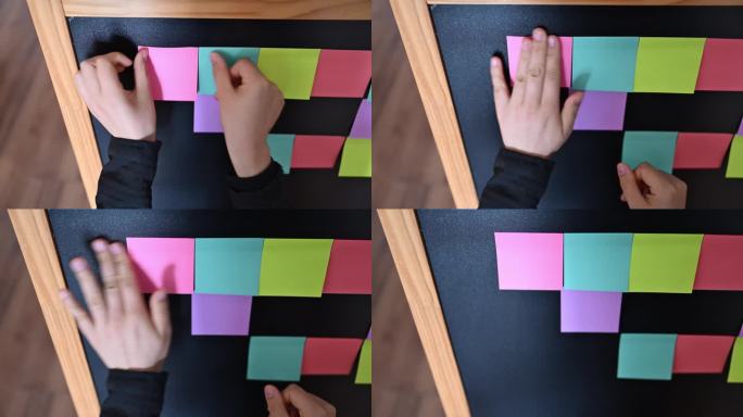 一位女士正在黑板上使用贴纸