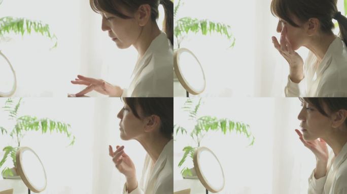 对着镜子涂眼霜的女人