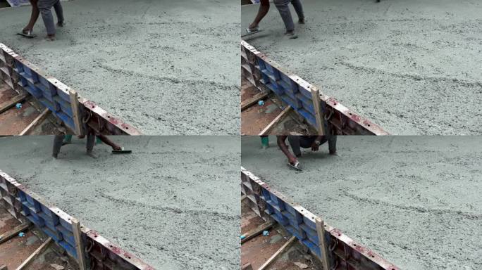 许多建筑工人帮忙平稳地浇筑水泥和抹灰。