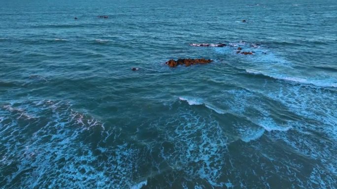 Waves at sunset on the Trengandin beach. Aerial vi