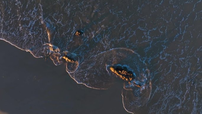 Waves at sunset on the Trengandin beach. Aerial vi