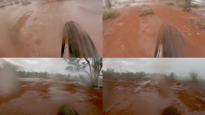 雨中骑自行车在农场，澳大利亚乡村的土路上