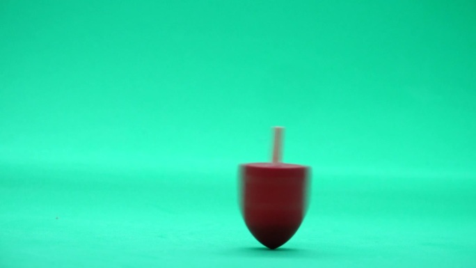 红色旋转陀螺转向绿色屏幕背景光明节犹太节日