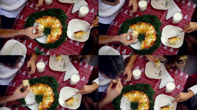 一家人坐在餐桌上吃Roscón德雷耶斯在圣诞节时间