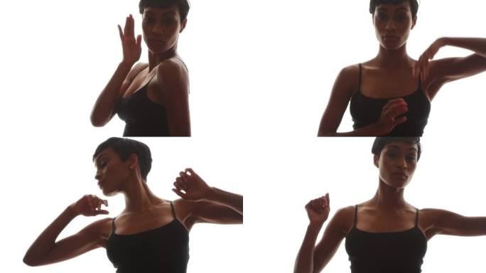 一名身穿黑衣的非洲妇女双手跳舞，脸转向镜头