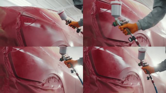 汽车喷漆工穿着防护服和口罩，在车间工作室中为汽车保险杠喷涂金属漆和清漆。汽车喷漆服务，优质汽车车身修