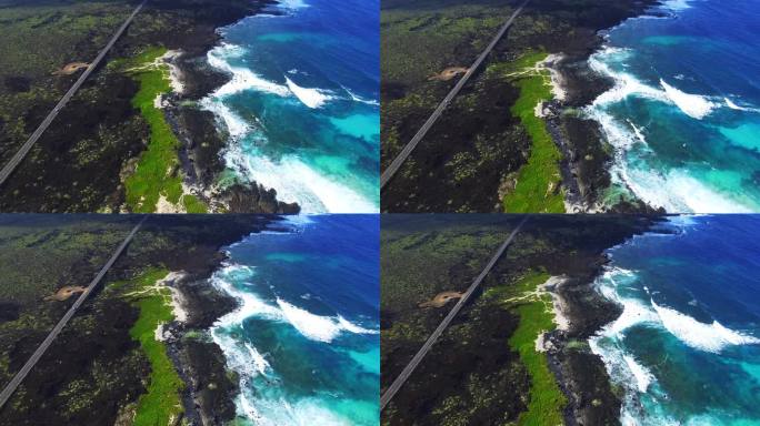 无人机在美丽的兰萨罗特火山岛北部海岸上空拍摄的航拍画面，海岸线上有一条笔直的长路，令人惊叹。4 k 