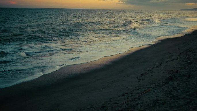夕阳映照在拍打的海浪上