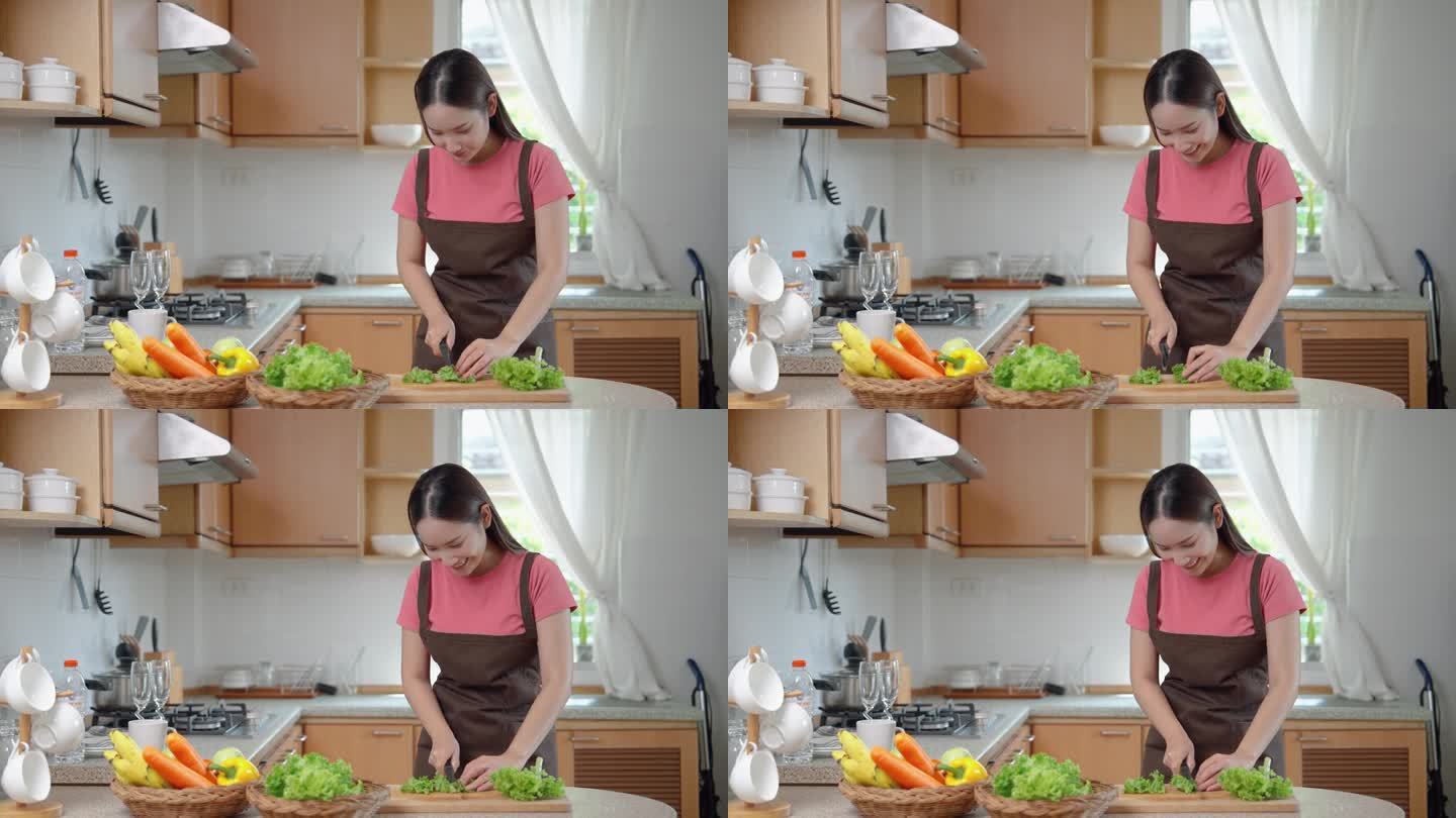 亚洲女性在厨房切菜和烹饪。