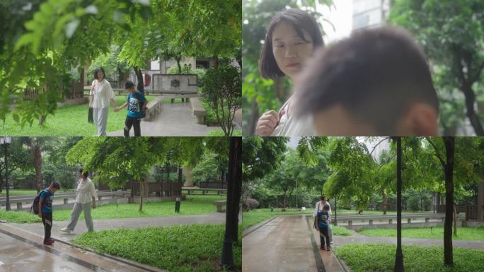 妈妈接儿子放学快乐童年儿子玩水