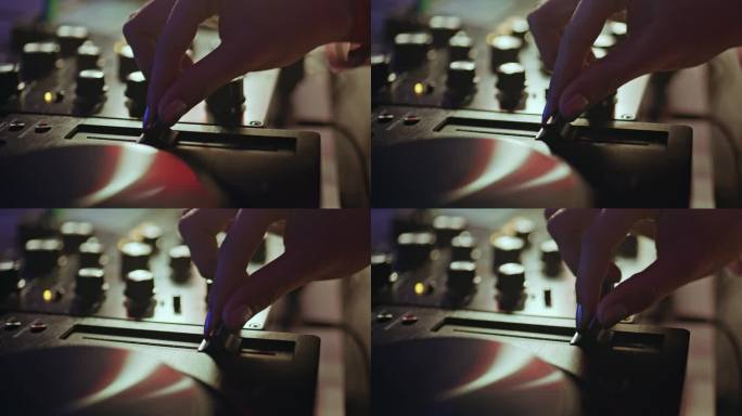 手在夜总会特写调整DJ设备的滑块。未知的DJ。