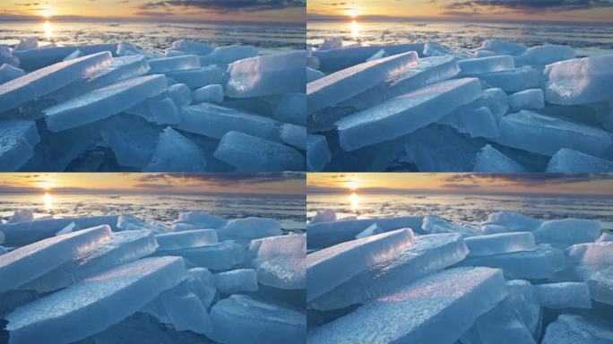 春天融化的冰。夕阳余晖下破碎的冰。海洋上的蓝色冰块。全球变暖和气候变化概念，冰的自然概念。云台4K拍
