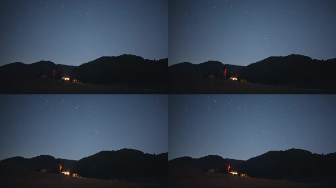 一群人坐在山中的篝火旁，仰望星空。