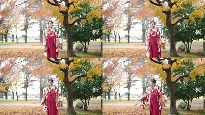 一位20多岁的年轻女性穿着日本传统的毕业典礼袴（和服），在一座传统日本房屋前的美丽地方漫步。
