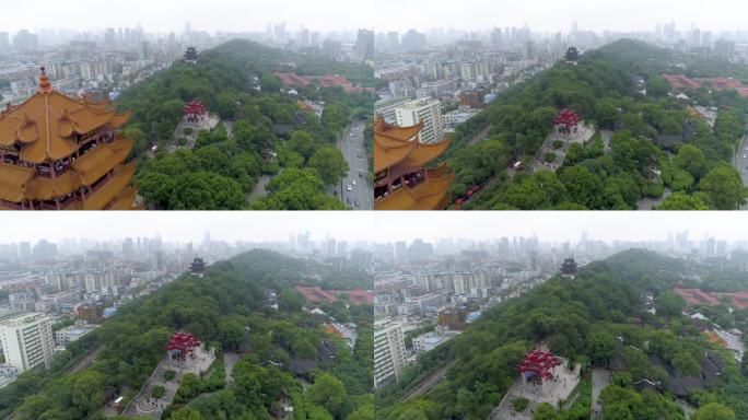 武汉，中国 - 2025年1月19日：航拍镜头展示了令人印象深刻的塔楼和环绕武汉的绿色山丘。