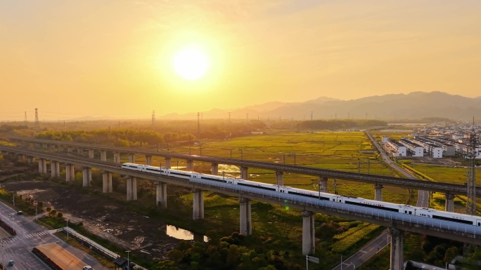 航拍高铁行驶在夕阳下