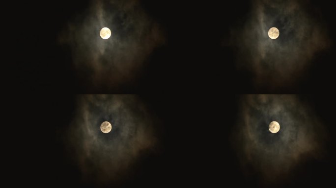 满月在黑暗的夜空中透过云层闪耀。