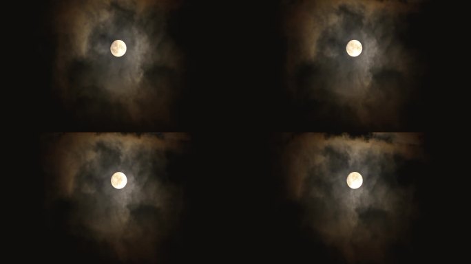 满月在夜空中透过黑暗的云层闪耀。