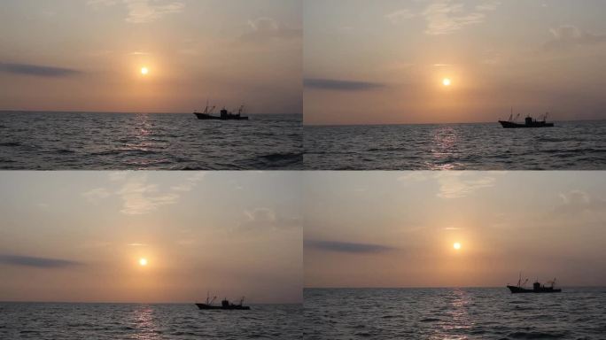 夕阳下渔船在大海上行驶