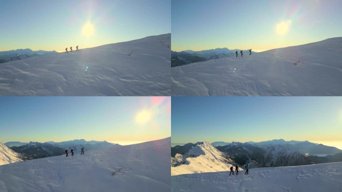 在阳光明媚的雪山坡上徒步向上。