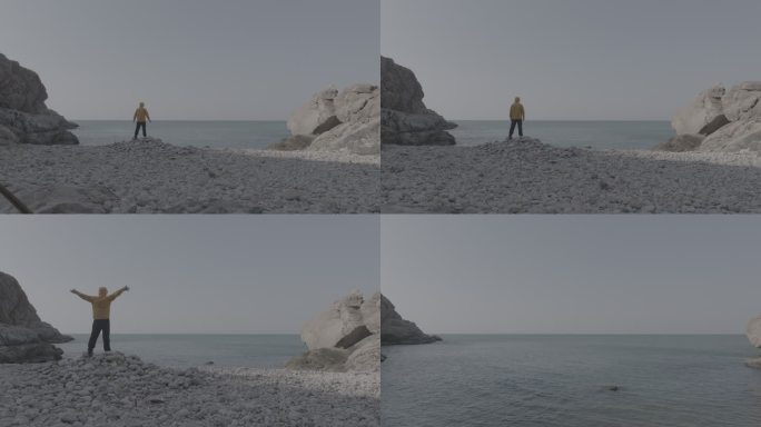 航拍威海靖子头鹅卵石海滩黄色冲锋衣飞手