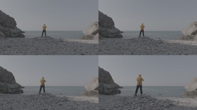航拍威海靖子头鹅卵石海滩黄色冲锋衣飞手