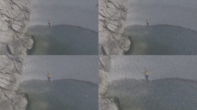 航拍威海靖子头鹅卵石海滩黄色冲锋衣飞手