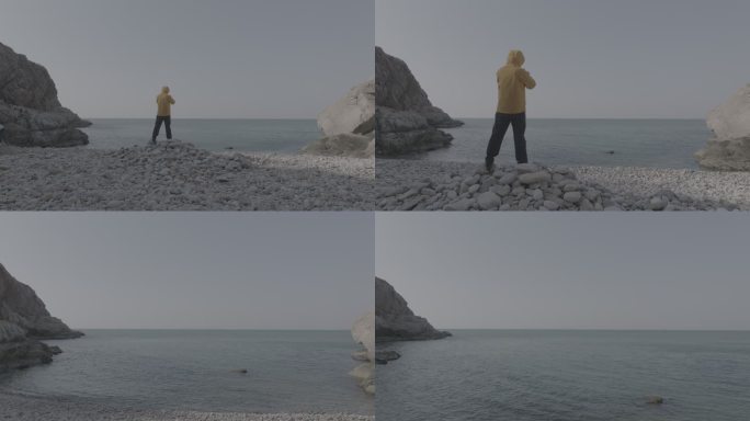 航拍威海靖子头鹅卵石海滩黄色冲锋衣飞手