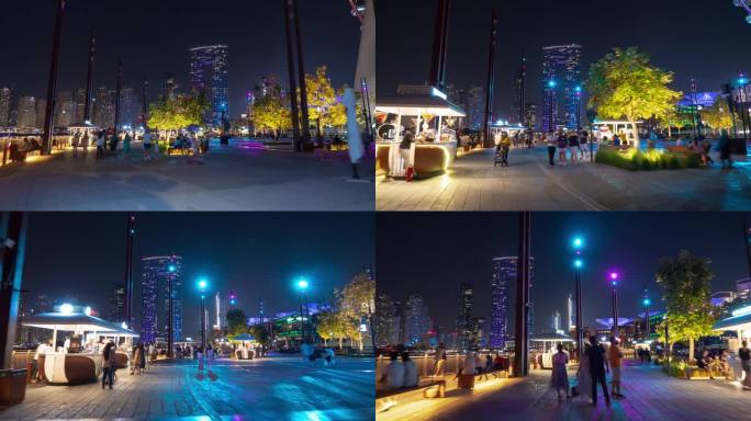 夜间照明，迪拜市著名的蓝色水域，繁忙的海滨长廊，码头景观，海湾漫步全景，4K延时摄影，阿联酋。