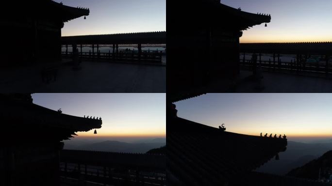 无人机拍摄远处橙色天际线映衬下的老君山顶庙宇建筑屋脊兽（建筑）